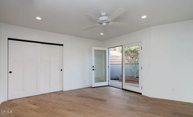 a view of a balcony with wooden floor and fence