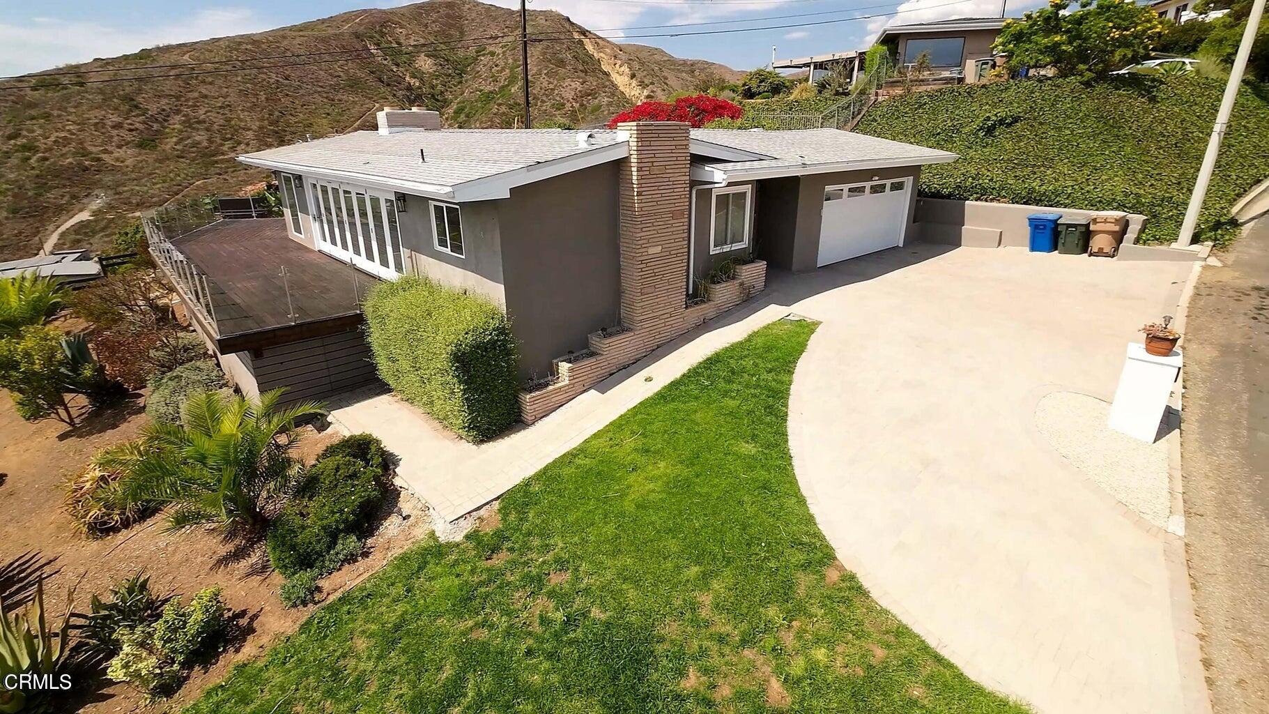 3026 Hilltop Drive Ventura, CA 93003 - Photo 18 of 31 a view of a house with a backyard and sitting area