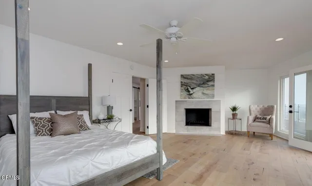 a bedroom with a bed and a fireplace