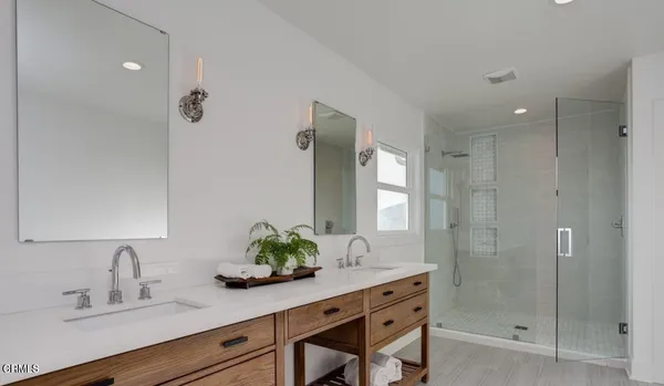 a bathroom with a shower sink and mirror
