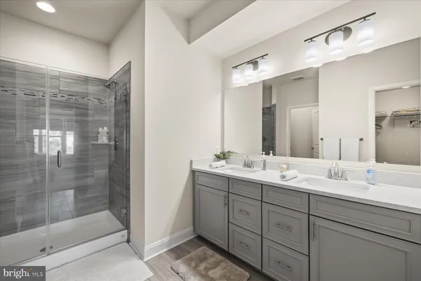 a bathroom with a shower sink and mirror