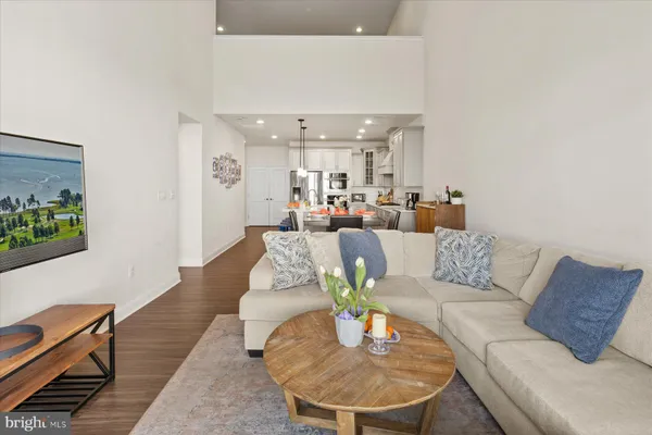 a living room with furniture and a dining table