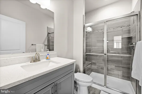 a bathroom with a sink toilet and shower