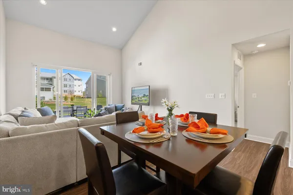 a open dining room with furniture and a floor to ceiling window
