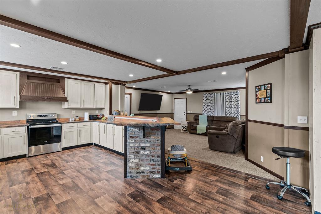 4638 Benton Road Bossier City, LA 71111 - Photo 12 of 34 a large white kitchen with a large window and stainless steel appliances