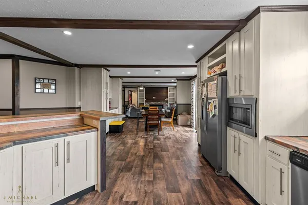 a kitchen with stainless steel appliances granite countertop a stove and a refrigerator