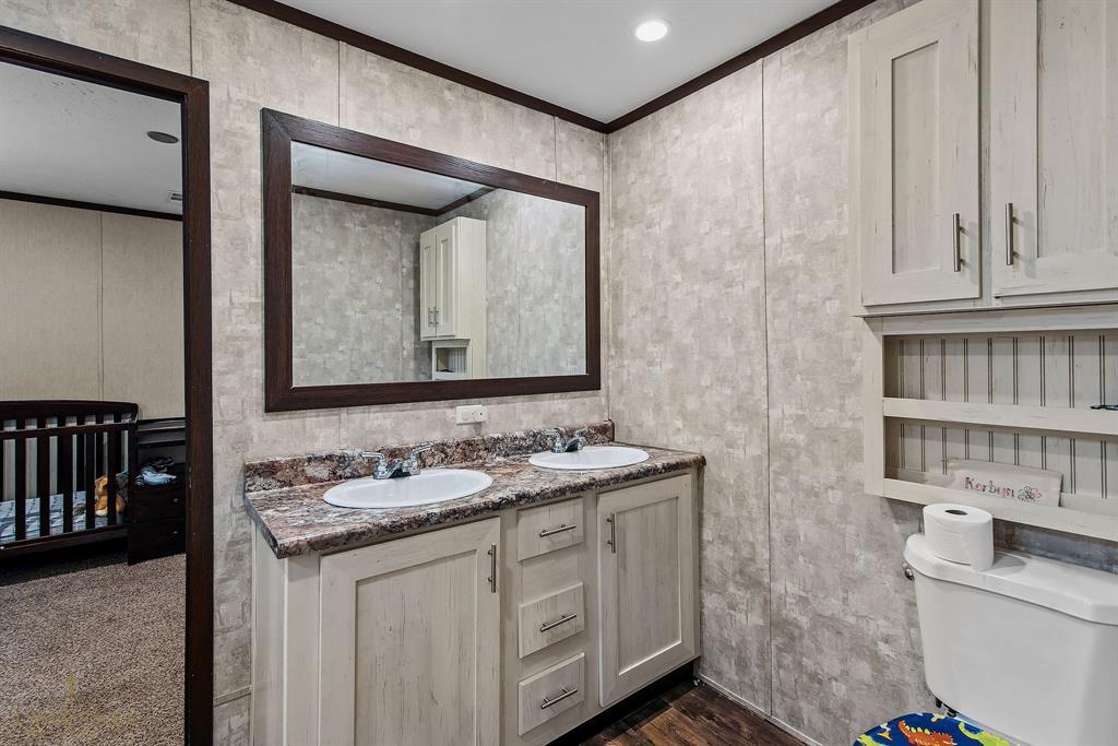 4638 Benton Road Bossier City, LA 71111 - Photo 21 of 34 a bathroom with a granite countertop sink and a mirror