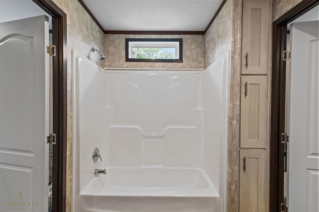 4638 Benton Road Bossier City, LA 71111 - Photo 22 of 34 a bathroom with a bathtub and shower