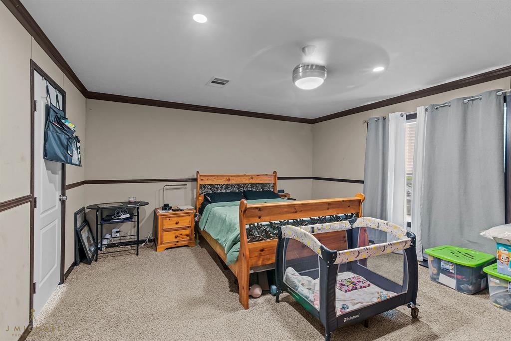 4638 Benton Road Bossier City, LA 71111 - Photo 26 of 34 a bedroom with furniture and a bathtub