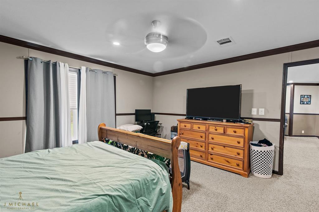 4638 Benton Road Bossier City, LA 71111 - Photo 27 of 34 a bedroom with furniture and flat screen tv