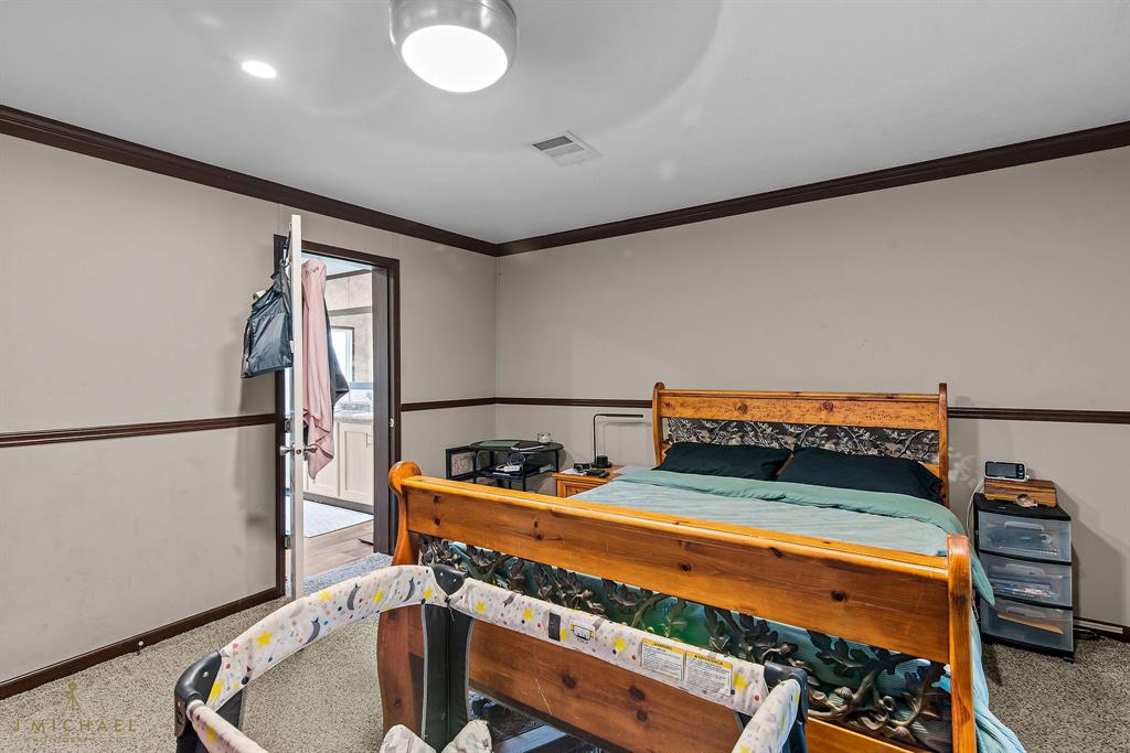 4638 Benton Road Bossier City, LA 71111 - Photo 28 of 34 a bedroom with furniture and a potted plant