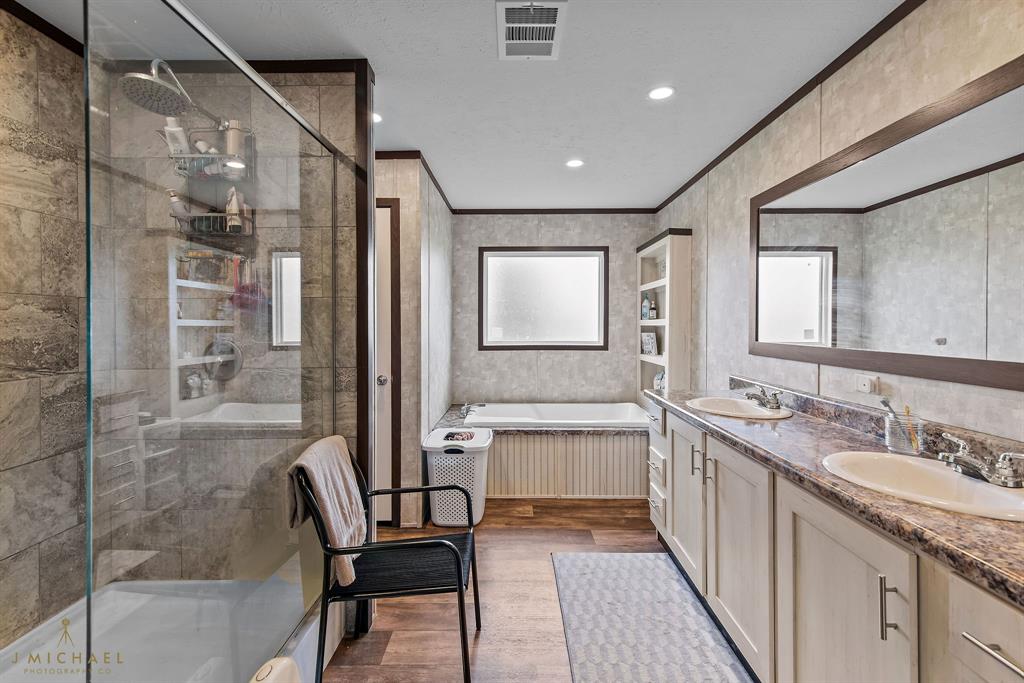 4638 Benton Road Bossier City, LA 71111 - Photo 29 of 34 a bathroom with a granite countertop sink mirror and a bathtub
