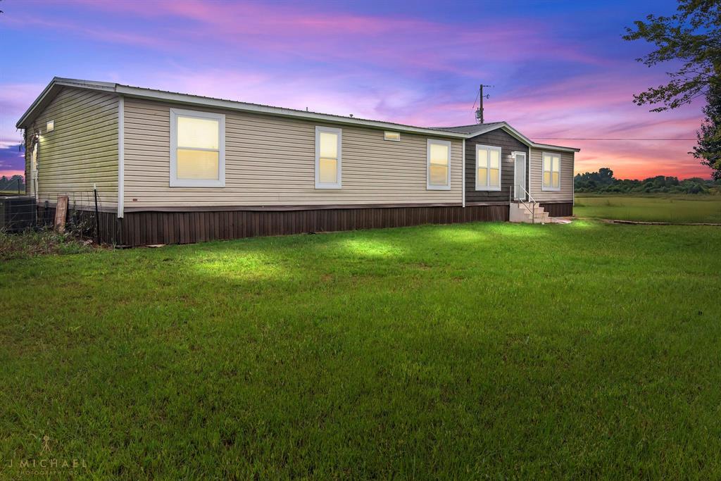 4638 Benton Road Bossier City, LA 71111 - Photo 3 of 34 a front view of a house with garden