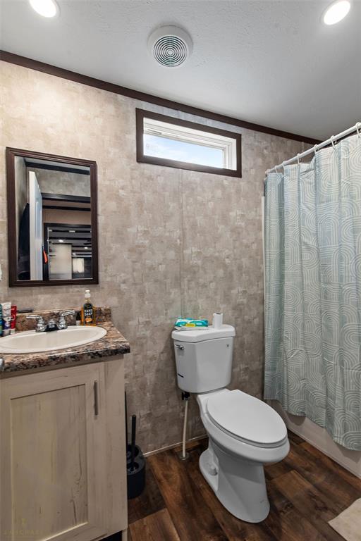 4638 Benton Road Bossier City, LA 71111 - Photo 33 of 34 a bathroom with a toilet a sink and a mirror