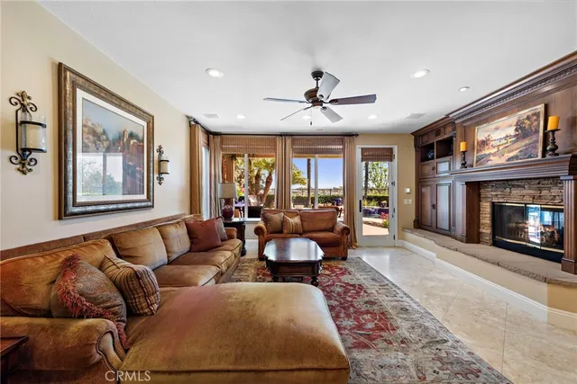 a living room with furniture ceiling fan and a rug