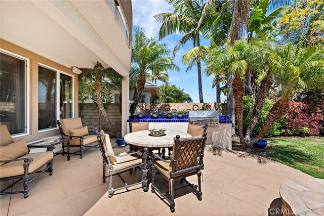 a view of a patio with a table and chairs