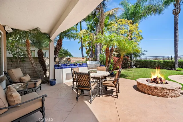 a view of a swimming pool with a yard and sitting area
