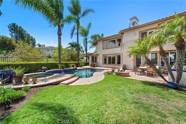 a view of a house with swimming pool and sitting area