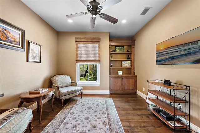 a spacious bedroom with a large bed a chandelier and windows