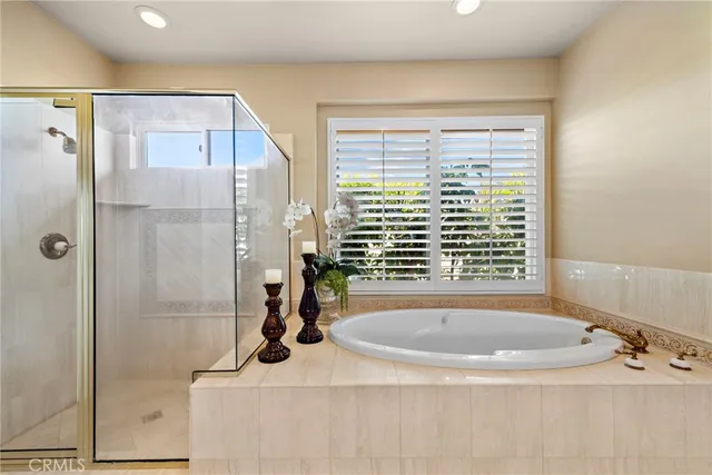 a bathroom with a double vanity sink mirror and shower