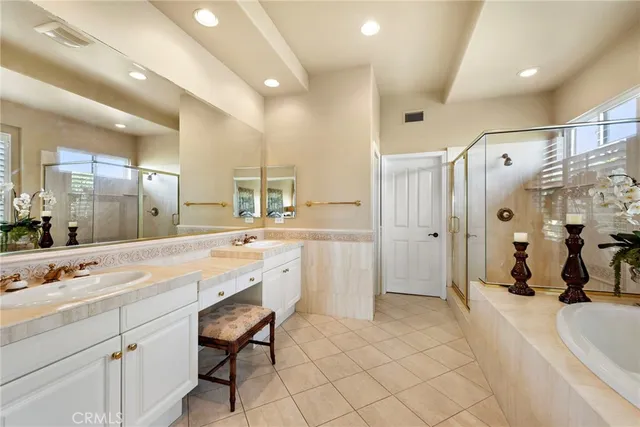a bed sitting in a spacious bedroom next to a window