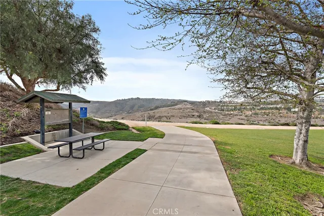 a view of a house with cars park