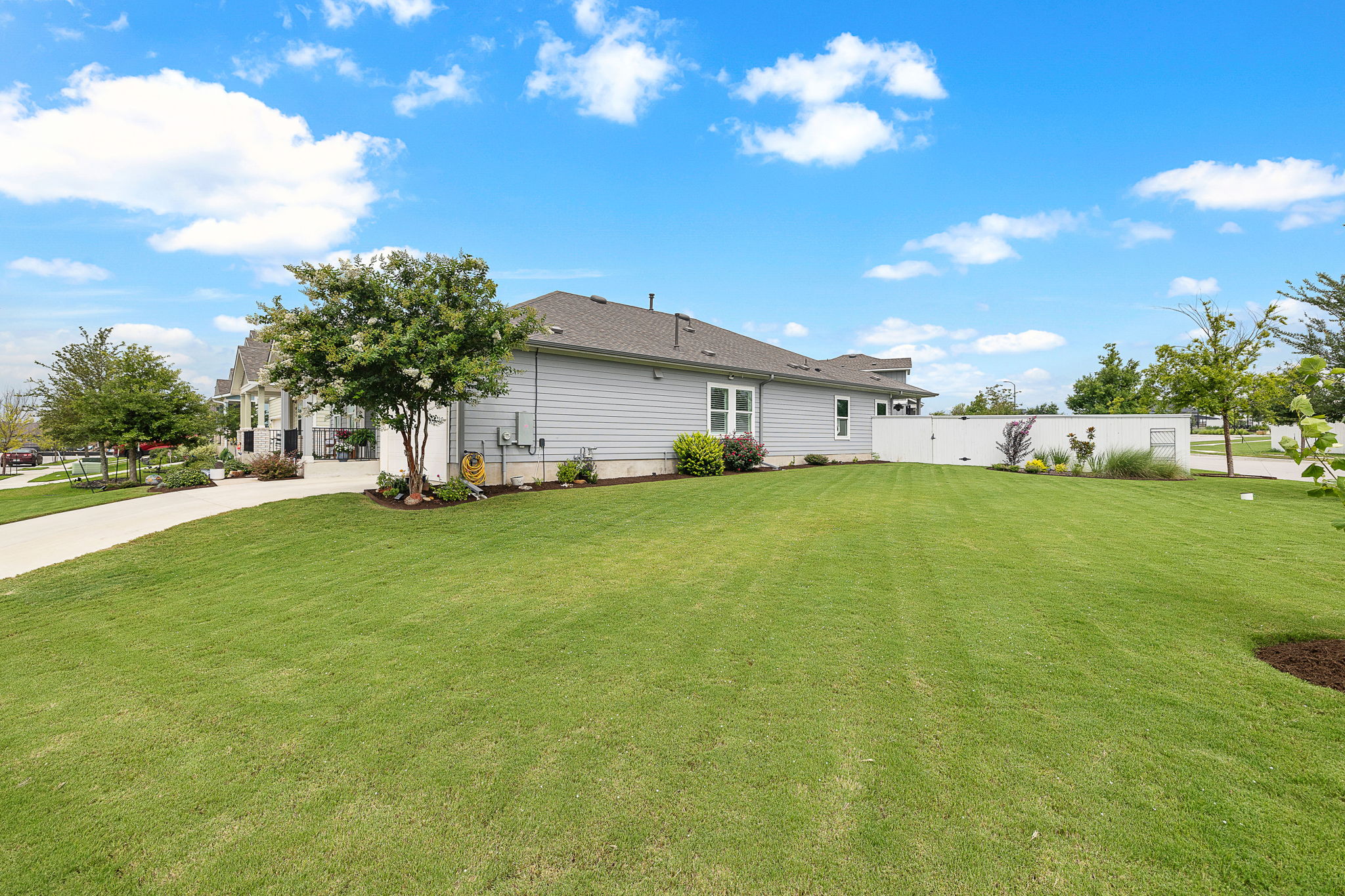 234 Appleberry Lane Elgin, TX 78621 - Photo 27 of 28 The oversized corner lot gives the home a generous side yard with extra green space and a polished, open feel.