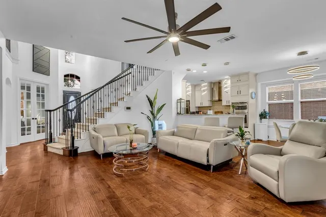 a living room with furniture and a wooden floor