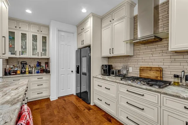 a kitchen with cabinets stainless steel appliances and a counter space