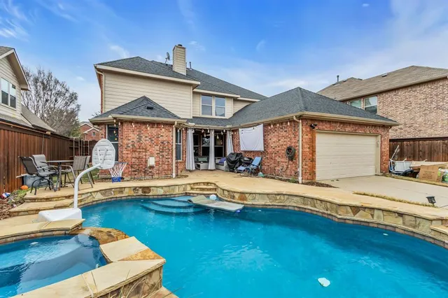 a front view of a house with swimming pool having outdoor seating