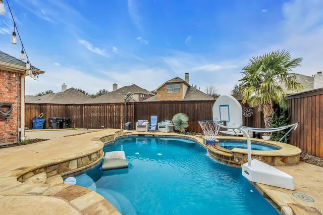 a view of a house with swimming pool and sitting area