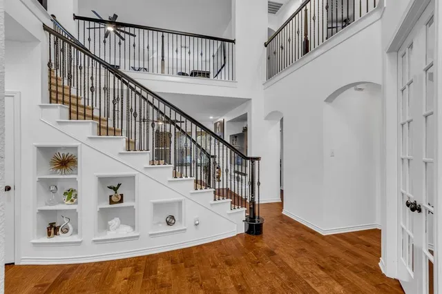 a view of entryway and hall with a wooden floor
