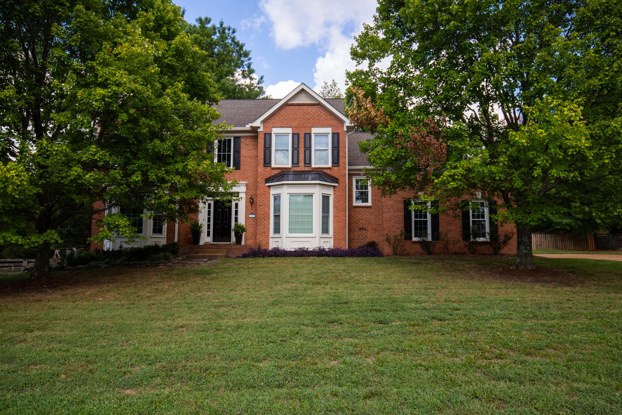 a front view of a house with a garden