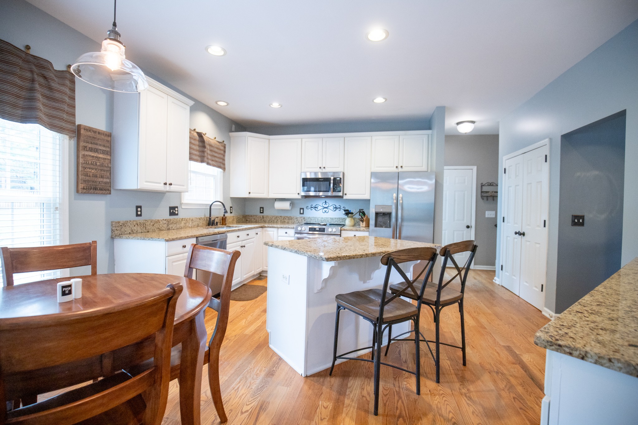 113 Chester Stevens Road Franklin, TN 37067 - Photo 11 of 31 a kitchen with stainless steel appliances kitchen island granite countertop a dining table chairs and sink