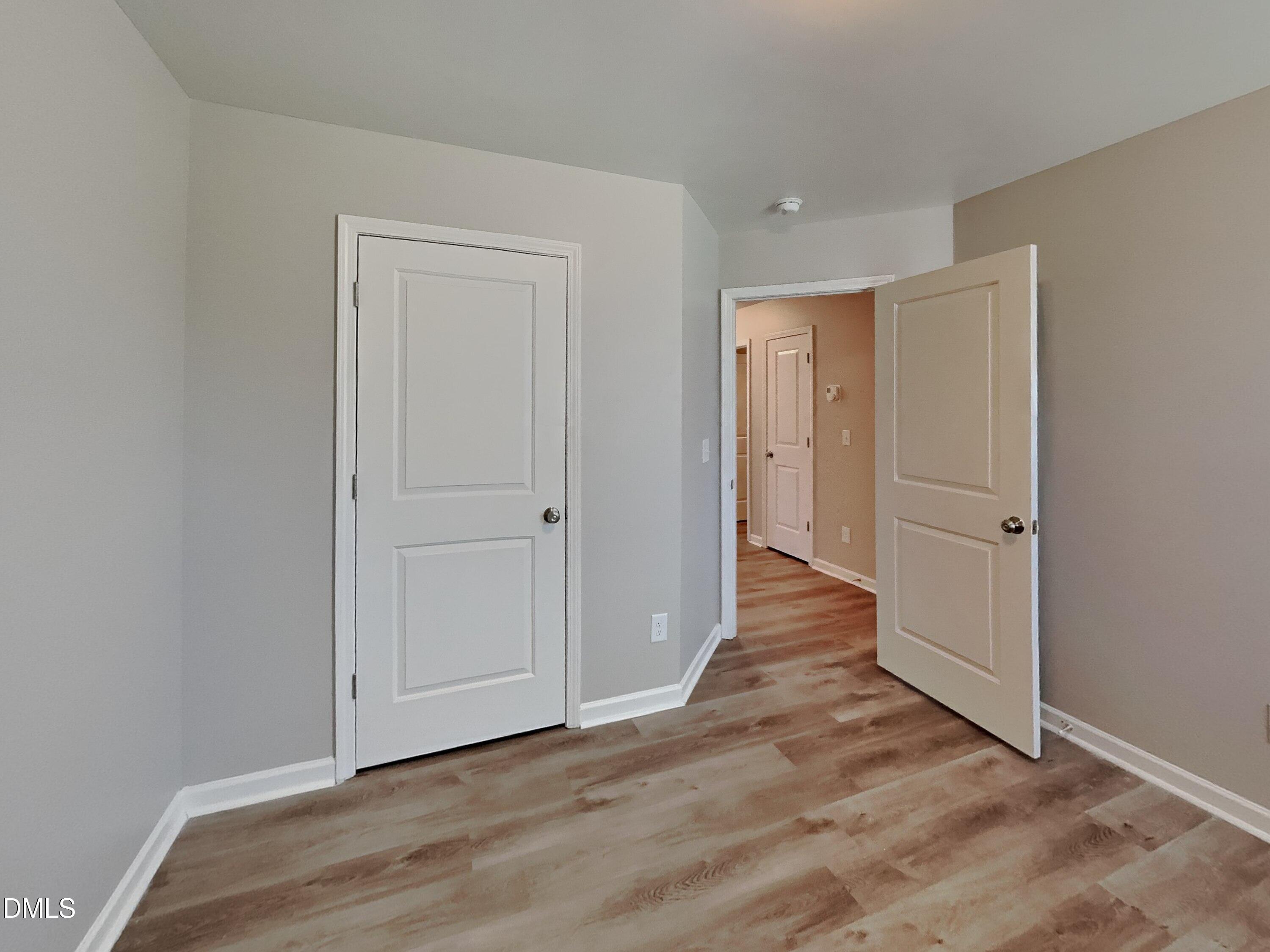 123 Willow Ridge Circle Willow Spring, NC 27592 - Photo 11 of 15 a view of an empty room with wooden floor and closet