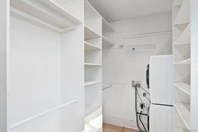 a view of walk in closet with empty racks