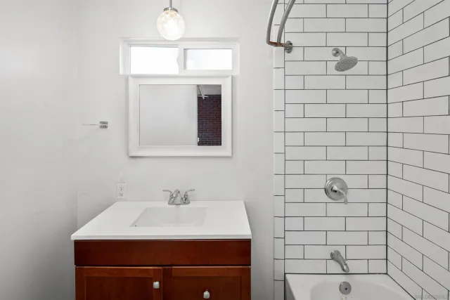 a bathroom with a sink a mirror and shower