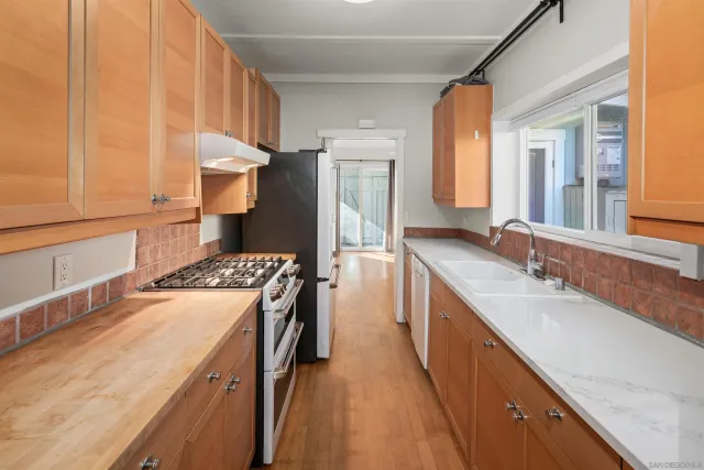 a kitchen with a sink stove and refrigerator
