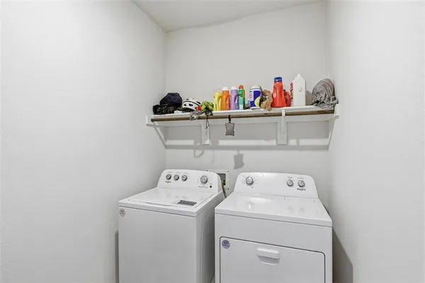 a view of storage and utility room with washer and dryer