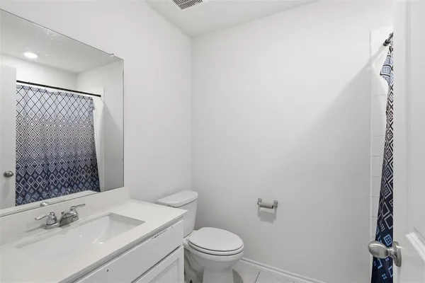 a bathroom with a sink vanity mirror and toilet