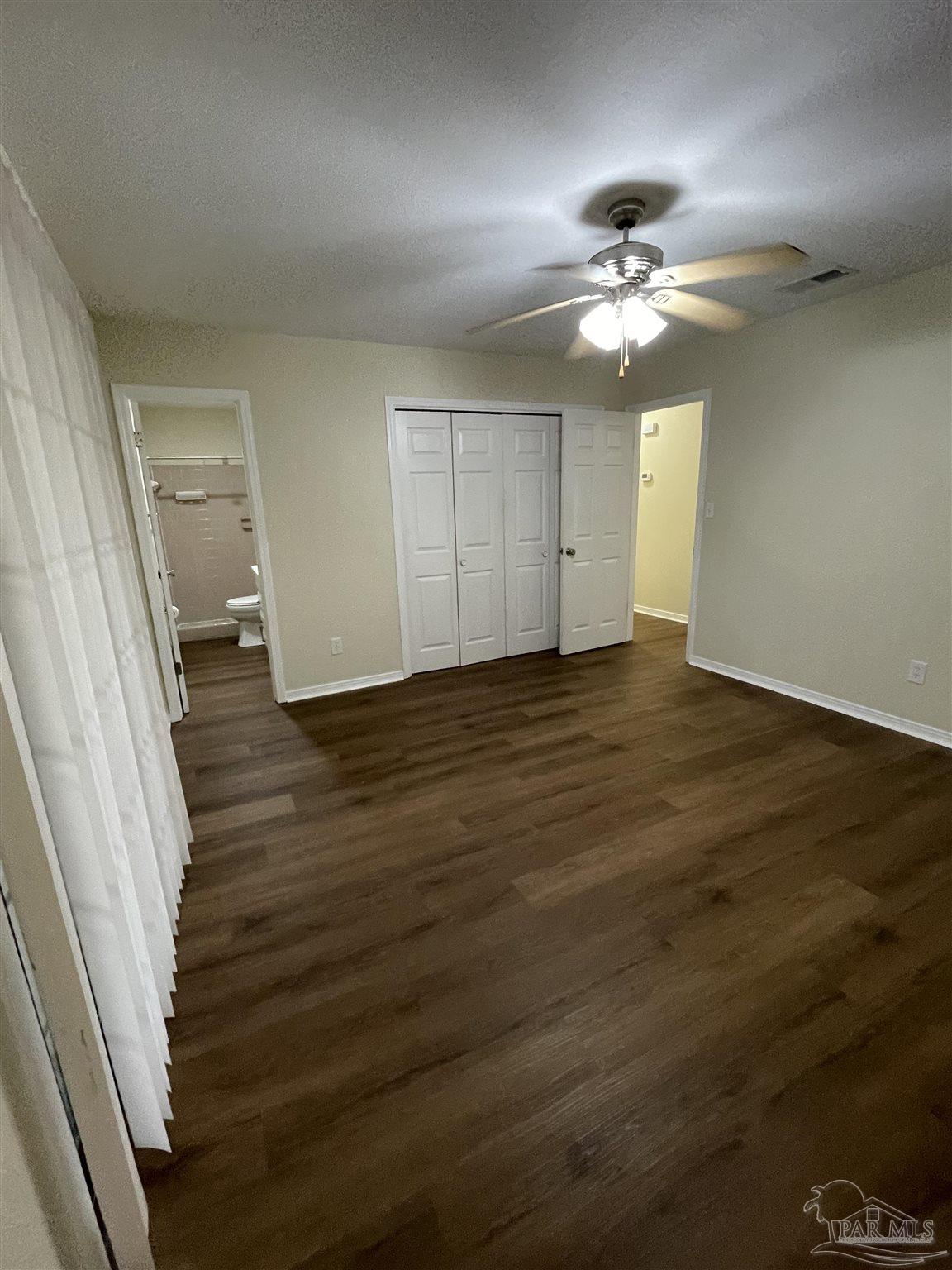 4140 April Road Pensacola, FL 32504 - Photo 5 of 12 wooden floor in an empty room with a window
