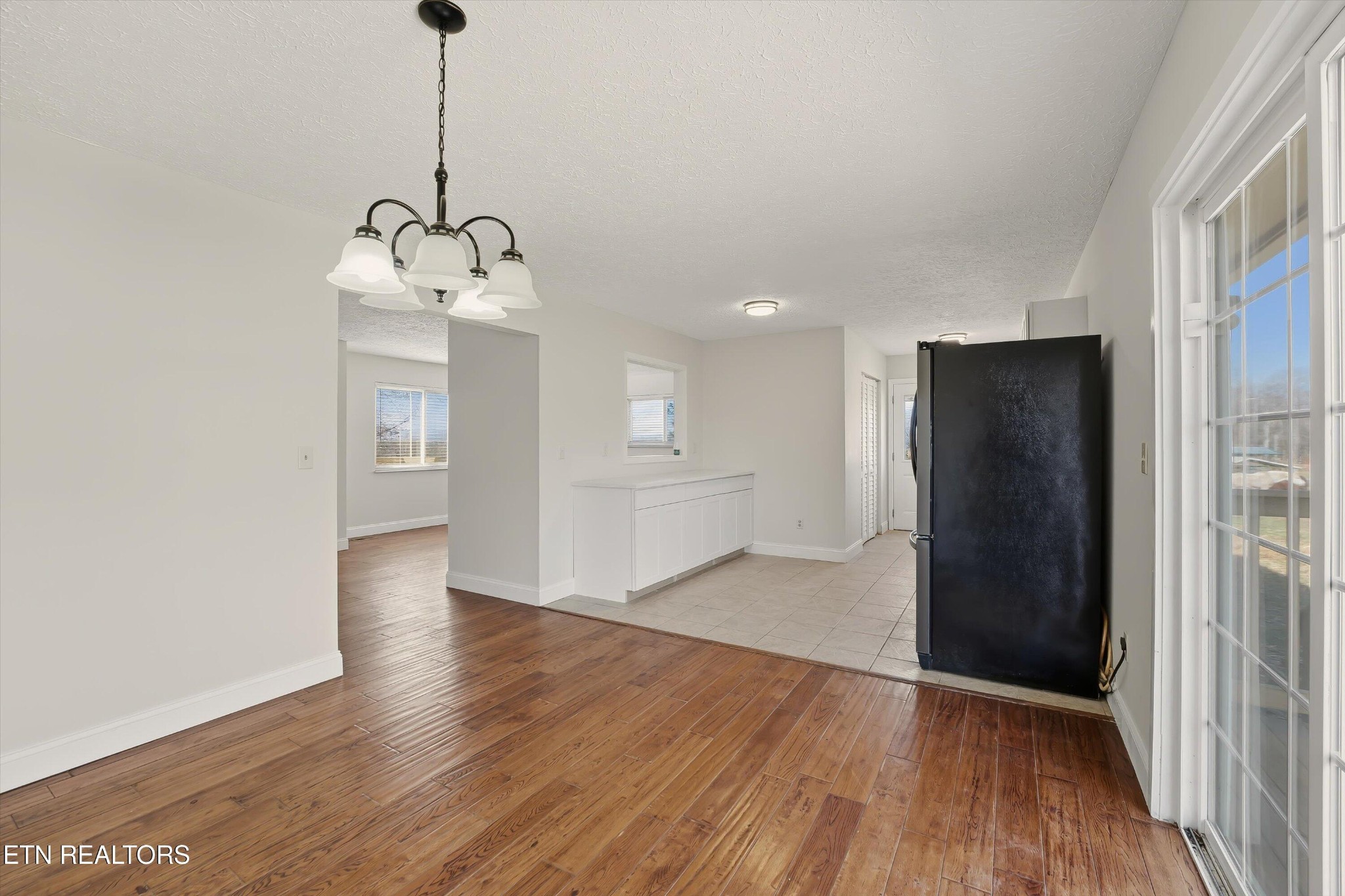 5413 Pryor Road Maryville, TN 37804 - Photo 13 of 33 a view of empty room with wooden floor and kitchen
