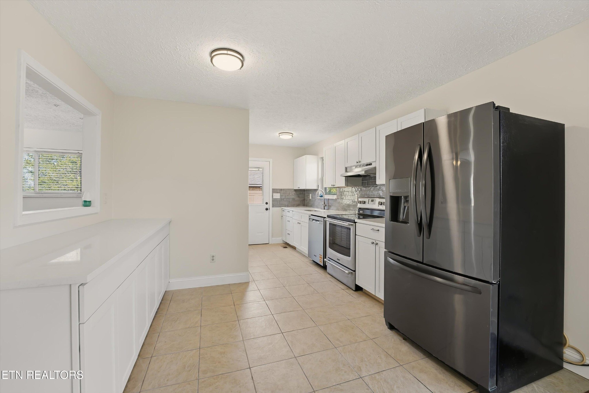 5413 Pryor Road Maryville, TN 37804 - Photo 14 of 33 a kitchen with stainless steel appliances a refrigerator sink and cabinets