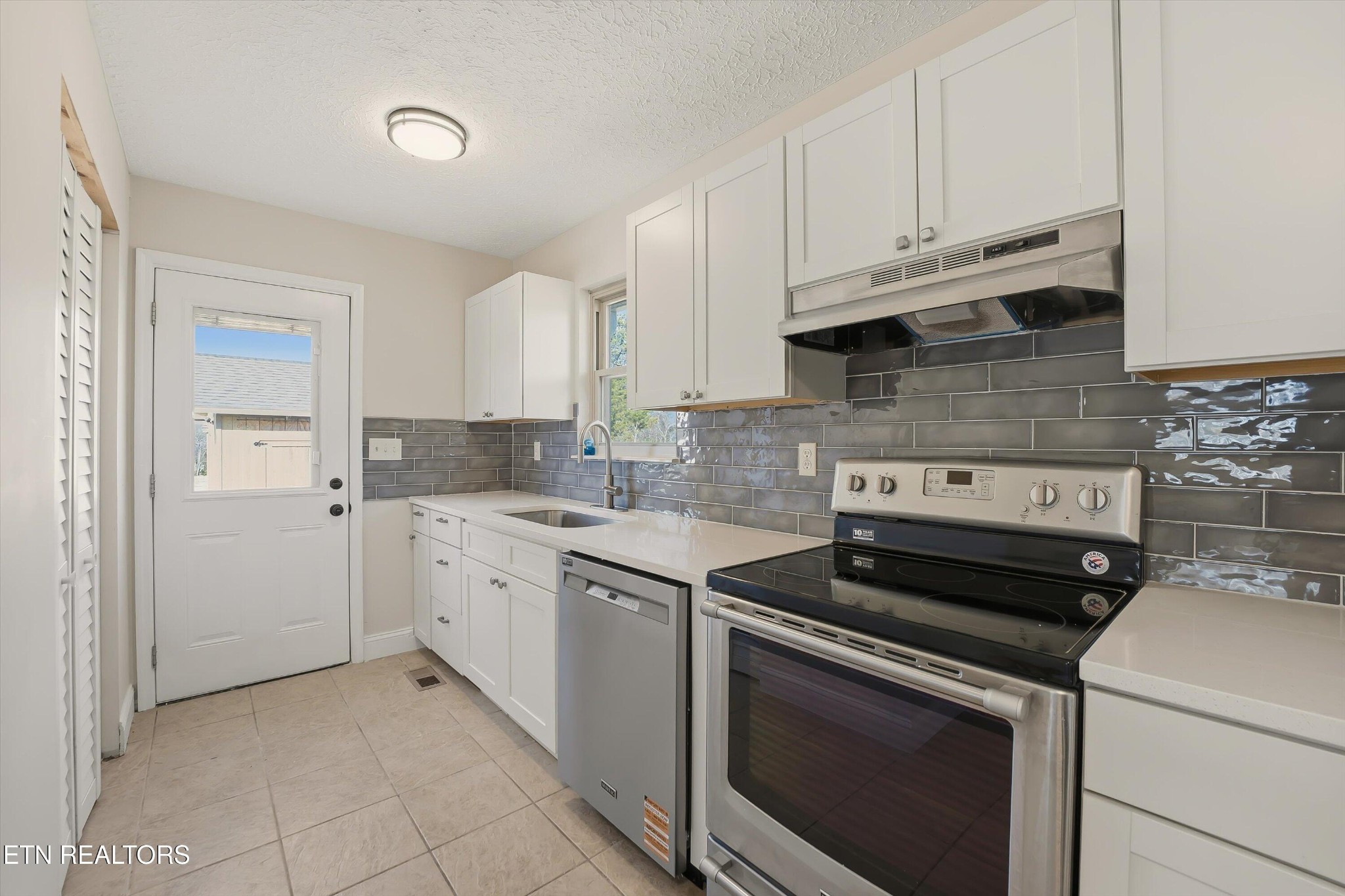 5413 Pryor Road Maryville, TN 37804 - Photo 16 of 33 a kitchen with cabinets appliances and a sink