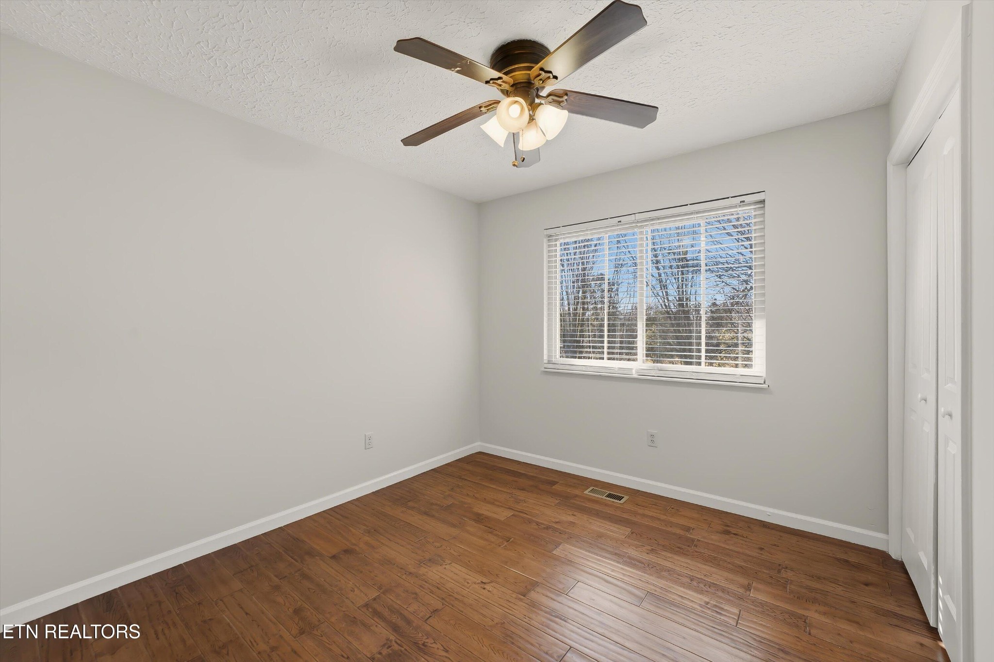 5413 Pryor Road Maryville, TN 37804 - Photo 21 of 33 a view of a room with wooden floor and a ceiling fan