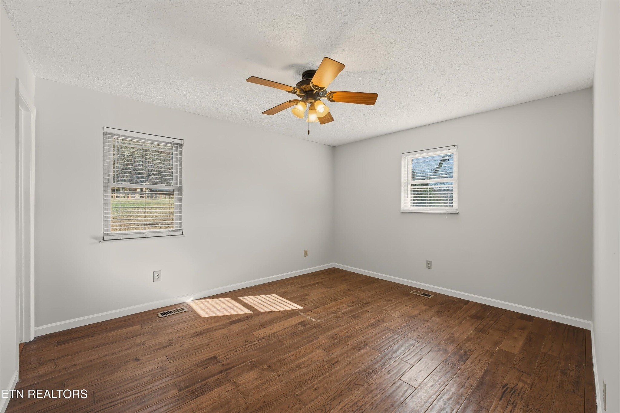 5413 Pryor Road Maryville, TN 37804 - Photo 23 of 33 a view of a room with wooden floor and a ceiling fan