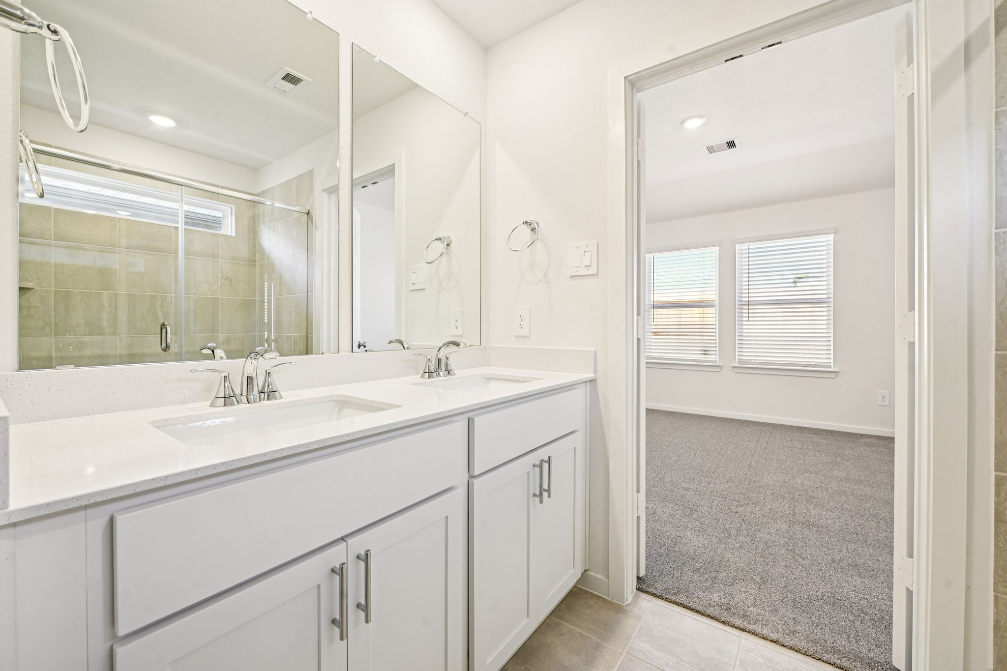 14147 Granger Pointe Lane Conroe, TX 77302 - Photo 21 of 35 a bathroom with a sink double vanity and a mirror