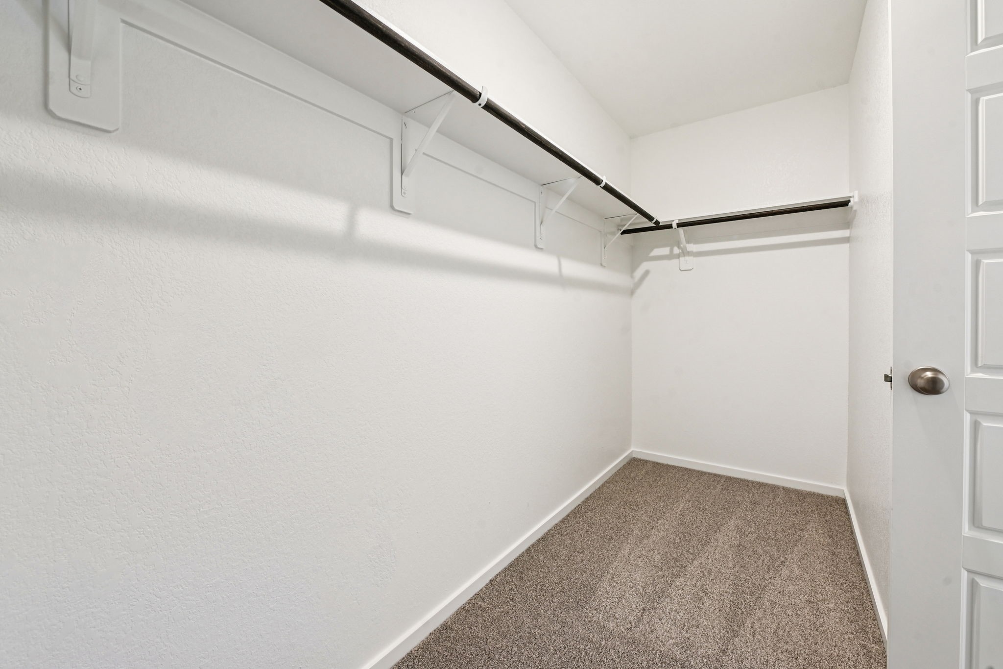 14147 Granger Pointe Lane Conroe, TX 77302 - Photo 22 of 35 a view of a room with racks on the wall