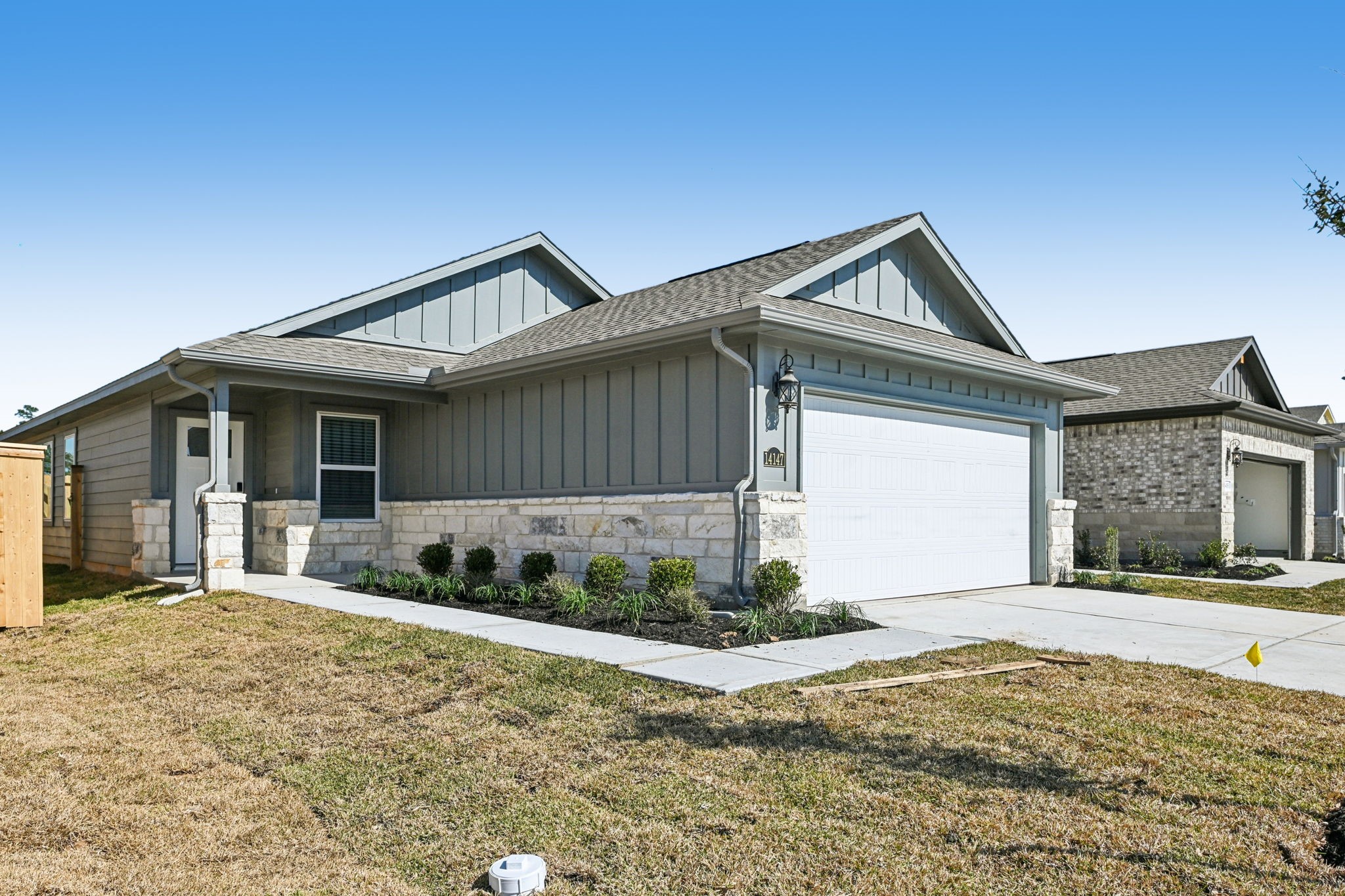 14147 Granger Pointe Lane Conroe, TX 77302 - Photo 3 of 35 a front view of a house with a yard and potted plants