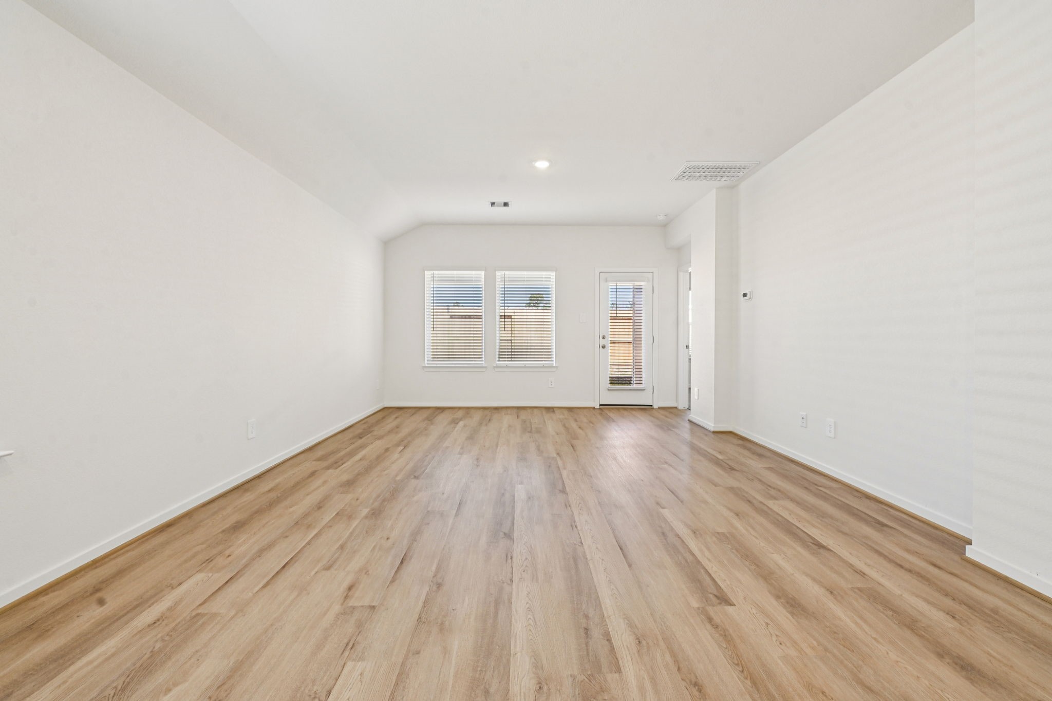 14147 Granger Pointe Lane Conroe, TX 77302 - Photo 6 of 35 an empty room with wooden floor and windows